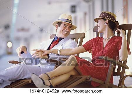 Close-up of a young couple sitting on a cruise ship and smiling View Large Photo Image Stock Image - Close-up of a young couple sitting on a cruise ship and smiling. Fotosearch