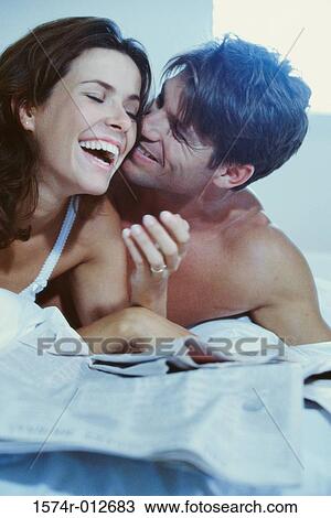 Close-up of a young couple smiling in bed View Large Photo Image Stock Image - Close-up of a young couple smiling in bed. Fotosearch
