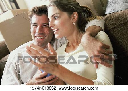 Close-up of a young couple smiling View Large Photo Image Stock Image - Close-up of a young couple smiling. Fotosearch