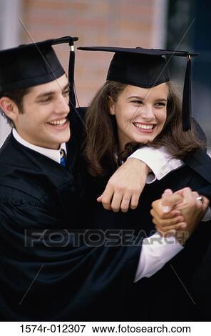 Close-up of a young graduate couple smiling View Large Photo Image Stock Photo - Close-up of a young graduate couple smiling. Fotosearch