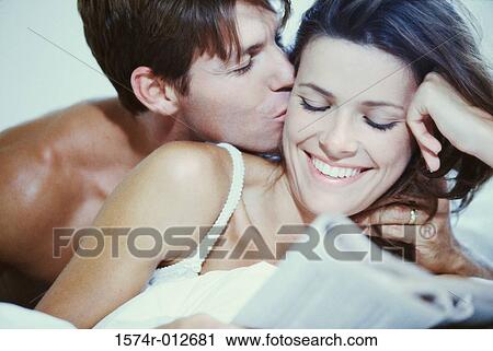 Stock Image - Close-up of a young man kissing a young woman. Fotosearch