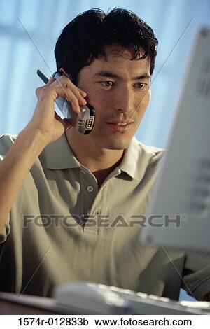 Stock Image - Close-up of a young man talking on the telephone. Fotosearch