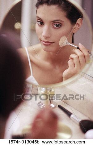 Close-up of a young woman applying blush View Large Photo Image Stock Image - Close-up of a young woman applying blush. Fotosearch