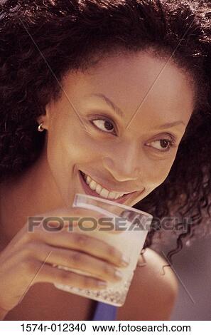 Close-up of a young woman drinking a glass of milk View Large Photo Image Stock Image - Close-up of a young woman drinking a glass of milk. Fotosearch