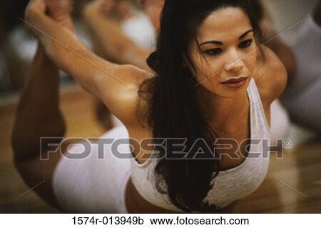 Close-up of a young woman exercising View Large Photo Image Stock Image - Close-up of a young woman exercising. Fotosearch