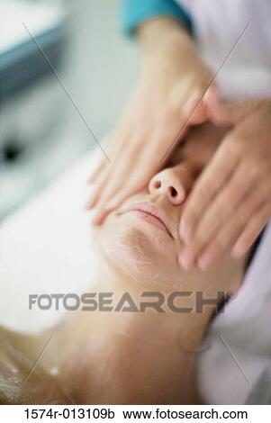 Close-up of a young woman getting a face massage View Large Photo Image Stock Image - Close-up of a young woman getting a face massage. Fotosearch