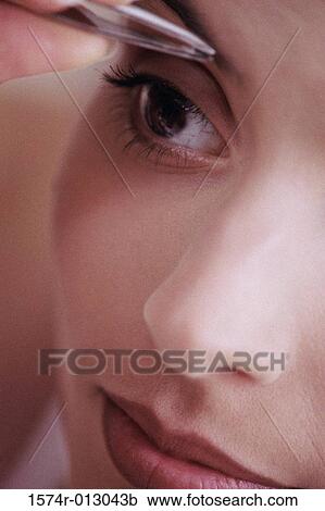Close-up of a young woman shaping eyebrows with tweezers View Large Photo Image Stock Image - Close-up of a young woman shaping eyebrows with tweezers. Fotosearch