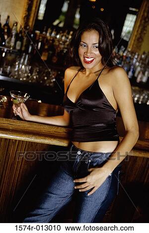 Close-up of a young woman smiling at a bar View Large Photo Image Stock Image - Close-up of a young woman smiling at a bar. Fotosearch