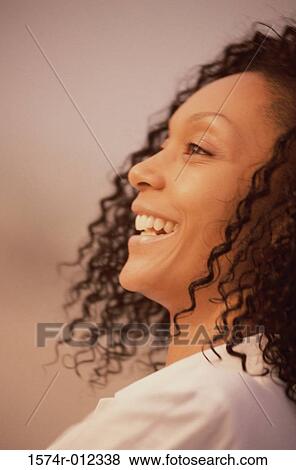 Close-up of a young woman smiling View Large Photo Image Stock Photo - Close-up of a young woman smiling. Fotosearch