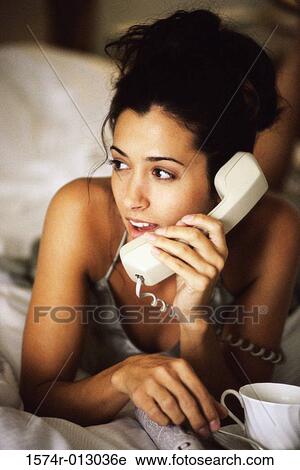Stock Image - Close-up of a young woman talking on the telephone. Fotosearch