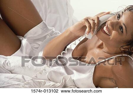 Close-up of a young woman talking on the telephone View Large Photo Image Stock Image - Close-up of a young woman talking on the telephone. Fotosearch