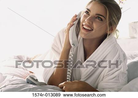 Stock Photo - Close-up of a young woman talking on the telephone. Fotosearch