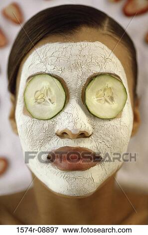 Close-up of a young woman wearing a facial mask View Large Photo Image Stock Photo - Close-up of a young woman wearing a facial mask. Fotosearch
