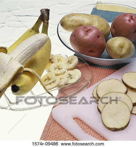Close-up of bananas and potatoes View Large Photo Image Stock Photograph - Close-up of bananas and potatoes. Fotosearch
