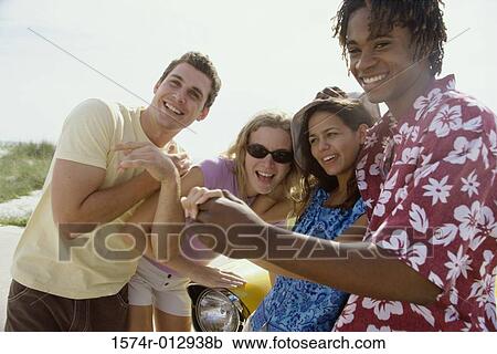Stock Image - Close-up of four teenagers smiling. Fotosearch