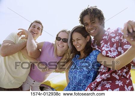 Stock Image - Close-up of four teenagers smiling. Fotosearch