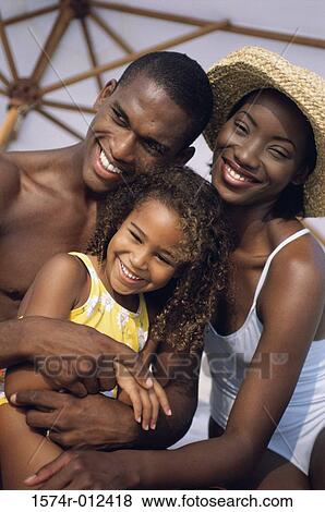 Close-up of parents and their daughter smiling View Large Photo Image Stock Photo - Close-up of parents and their daughter smiling. Fotosearch