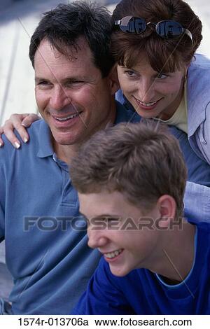 Close-up of parents and their son smiling View Large Photo Image Stock Image - Close-up of parents and their son smiling. Fotosearch