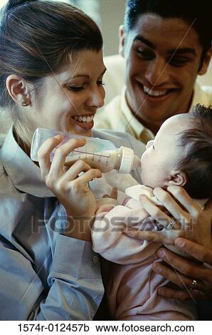 Close-up of parents feeding their son View Large Photo Image Stock Image - Close-up of parents feeding their son. Fotosearch