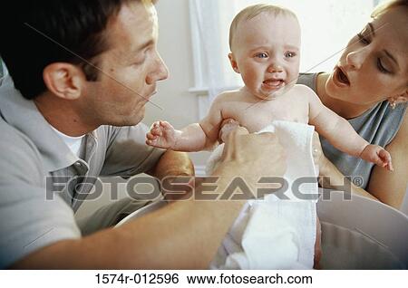 Close-up of parents giving their son a bath View Large Photo Image Stock Photograph - Close-up of parents giving their son a bath. Fotosearch