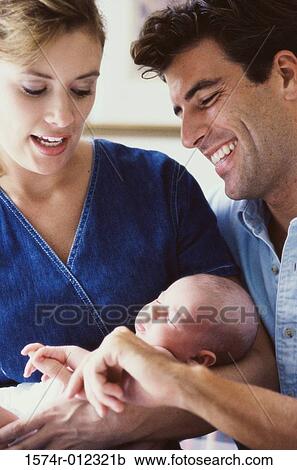 Close-up of parents holding their son View Large Photo Image Stock Image - Close-up of parents holding their son. Fotosearch