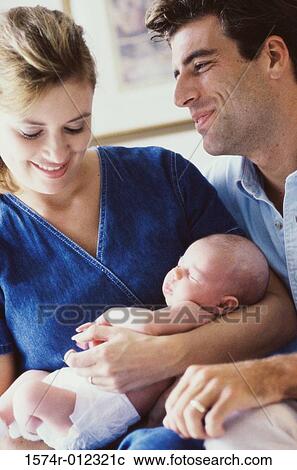 Stock Image - Close-up of parents holding their son. Fotosearch