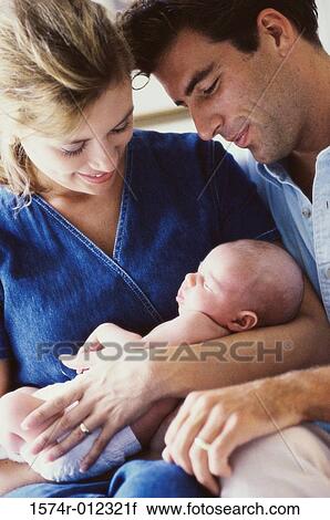 Stock Image - Close-up of parents holding their son. Fotosearch