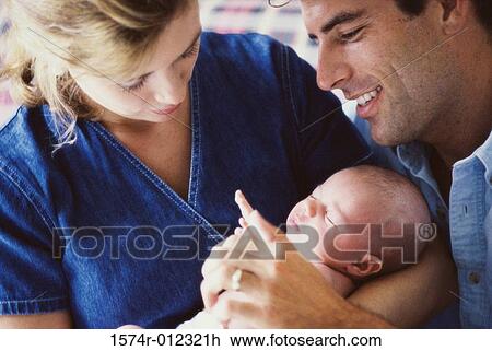 Close-up of parents holding their son View Large Photo Image Stock Image - Close-up of parents holding their son. Fotosearch