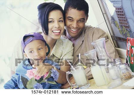 Close-up of parents sitting with their son View Large Photo Image Stock Image - Close-up of parents sitting with their son. Fotosearch