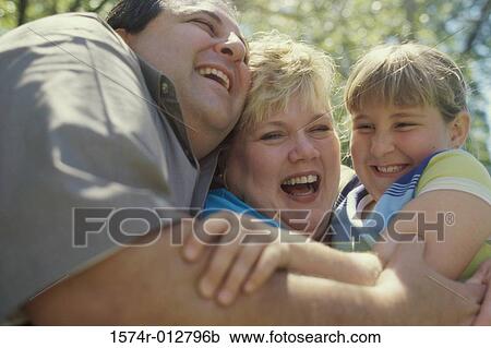 Close-up of parents smiling with their daughter View Large Photo Image Stock Image - Close-up of parents smiling with their daughter. Fotosearch