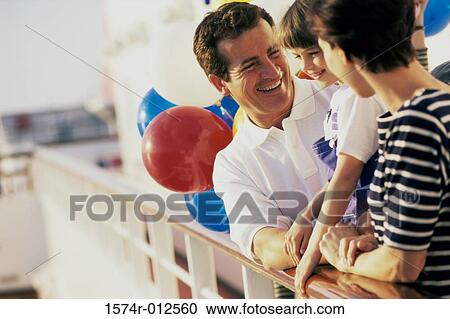 Close-up of parents standing with their daughter on a cruise ship View Large Photo Image Stock Image - Close-up of parents standing with their daughter on a cruise ship. Fotosearch