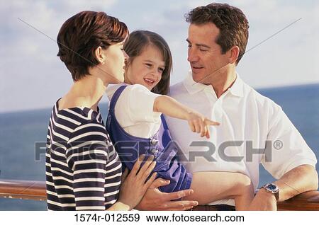 Close-up of parents standing with their daughter on a cruise ship View Large Photo Image Stock Photo - Close-up of parents standing with their daughter on a cruise ship. Fotosearch