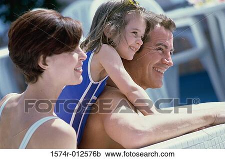 Close-up of parents with their daughter smiling on a cruise ship View Large Photo Image Stock Image - Close-up of parents with their daughter smiling on a cruise ship. Fotosearch