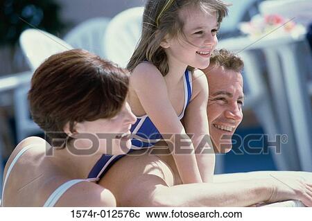 Close-up of parents with their daughter smiling on a cruise ship View Large Photo Image Stock Image - Close-up of parents with their daughter smiling on a cruise ship. Fotosearch