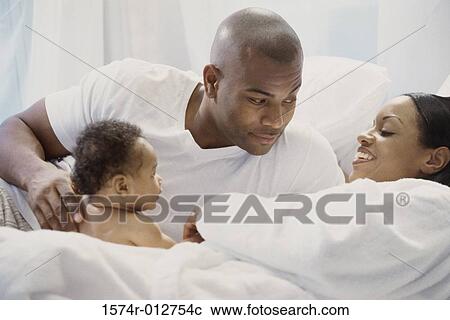 Stock Image - Close-up of parents with their son. Fotosearch