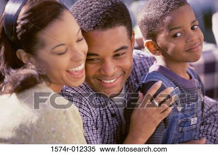 Stock Photography - Close-up of parents with their son smiling. Fotosearch