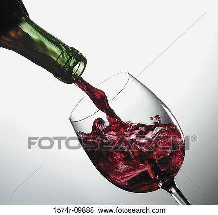 Close-up of red wine being poured from a bottle into a glass View Large Photo Image Stock Photo - Close-up of red wine being poured from a bottle into a glass. Fotosearch