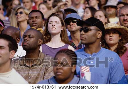 Stock Image - Close-up of spectators looking curious. Fotosearch