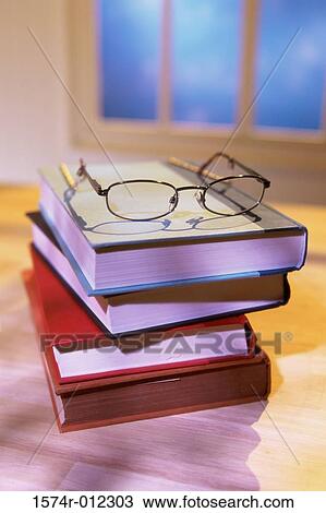 Close-up of stack of books with eyeglasses on it View Large Photo Image Stock Image - Close-up of stack of books with eyeglasses on it. Fotosearch