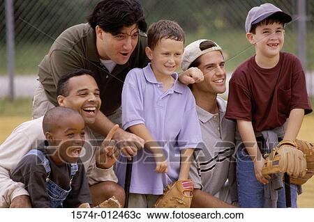 Stock Image - Close-up of three fathers with their sons wearing baseball gloves in a baseball field. Fotosearch
