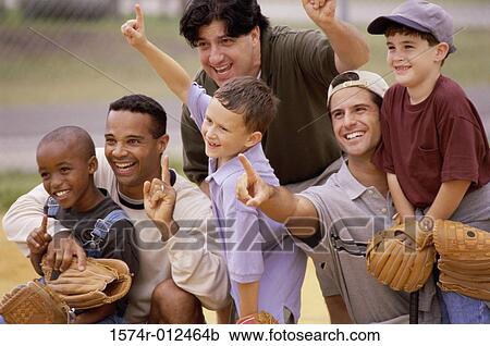 Stock Image - Close-up of three fathers with their sons wearing baseball gloves in a baseball field. Fotosearch