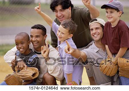Stock Image - Close-up of three fathers with their sons wearing baseball gloves in a baseball field. Fotosearch