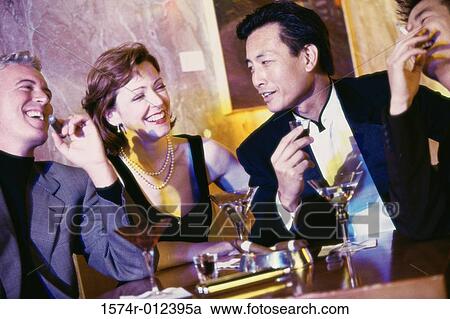 Close-up of three mid adult men and a mid adult woman in a bar View Large Photo Image Stock Image - Close-up of three mid adult men and a mid adult woman in a bar. Fotosearch
