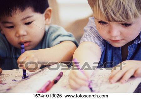 Close-up of two boys drawing with crayons View Large Photo Image Stock Photograph - Close-up of two boys drawing with crayons. Fotosearch