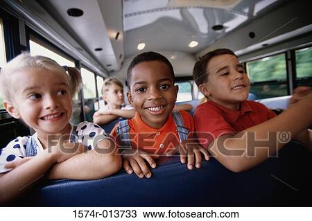 Close-up of two schoolboys and a schoolgirl sitting in a school bus View Large Photo Image Stock Image - Close-up of two schoolboys and a schoolgirl sitting in a school bus. Fotosearch
