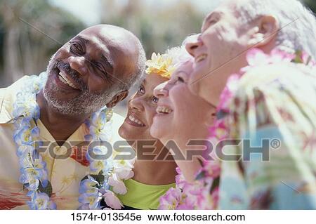 Stock Image - Close-up of two senior couples looking up. Fotosearch
