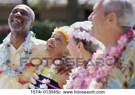 Stock Image - Close-up of two senior couples smiling. Fotosearch