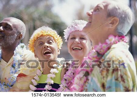 Stock Image - Close-up of two senior couples smiling. Fotosearch