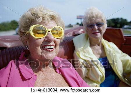 Close-up of two senior women sitting in a convertible car View Large Photo Image Picture - Close-up of two senior women sitting in a convertible car. Fotosearch