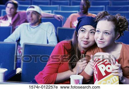Close-up of two teenage girls sitting in a movie theater View Large Photo Image Stock Image - Close-up of two teenage girls sitting in a movie theater. Fotosearch